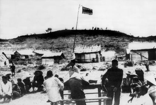 Vietnamese flag flying over the village of My Lai.